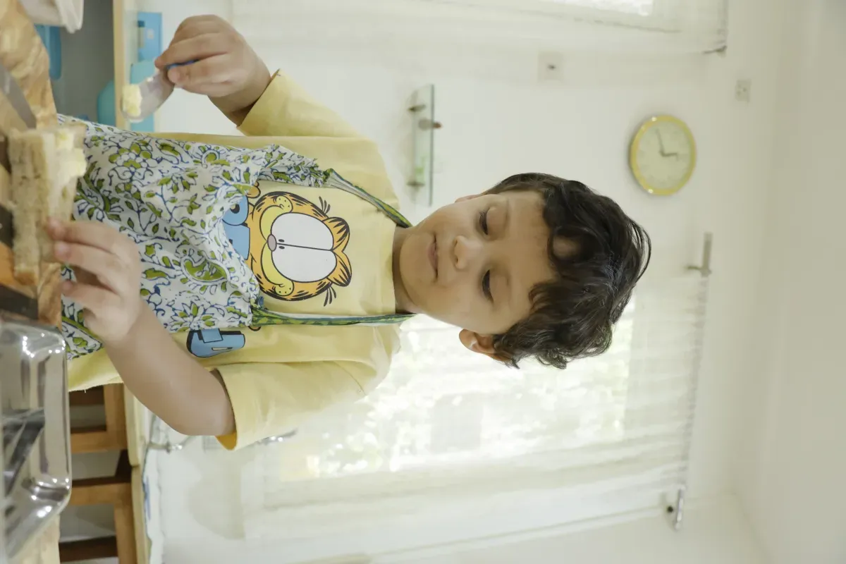 Toddler cutting fruits — food preparation